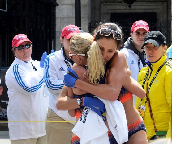 Kara Goucher and Shalane Flanagan embrace after completing the 2013 Boston Marathon. (Photo by Kristen Keesee/BU News Service)