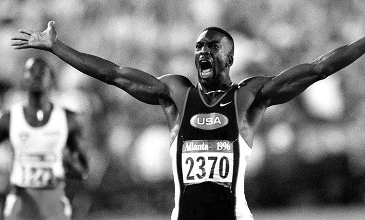 Michael Johnson participating in the 1996 Olympics on Team USA, the definition of a runner's body.