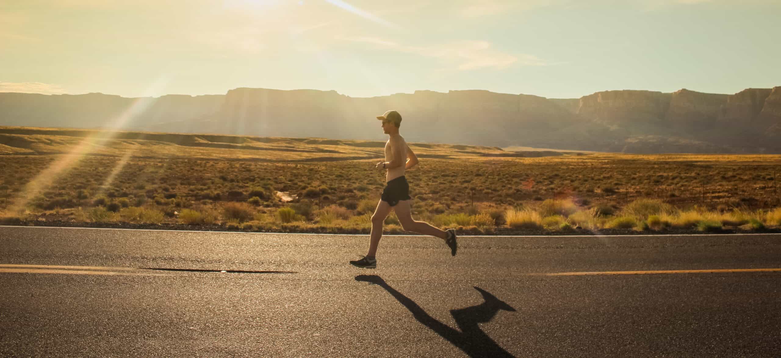 A runner running against a scenic backdrop training with half marathon tips.