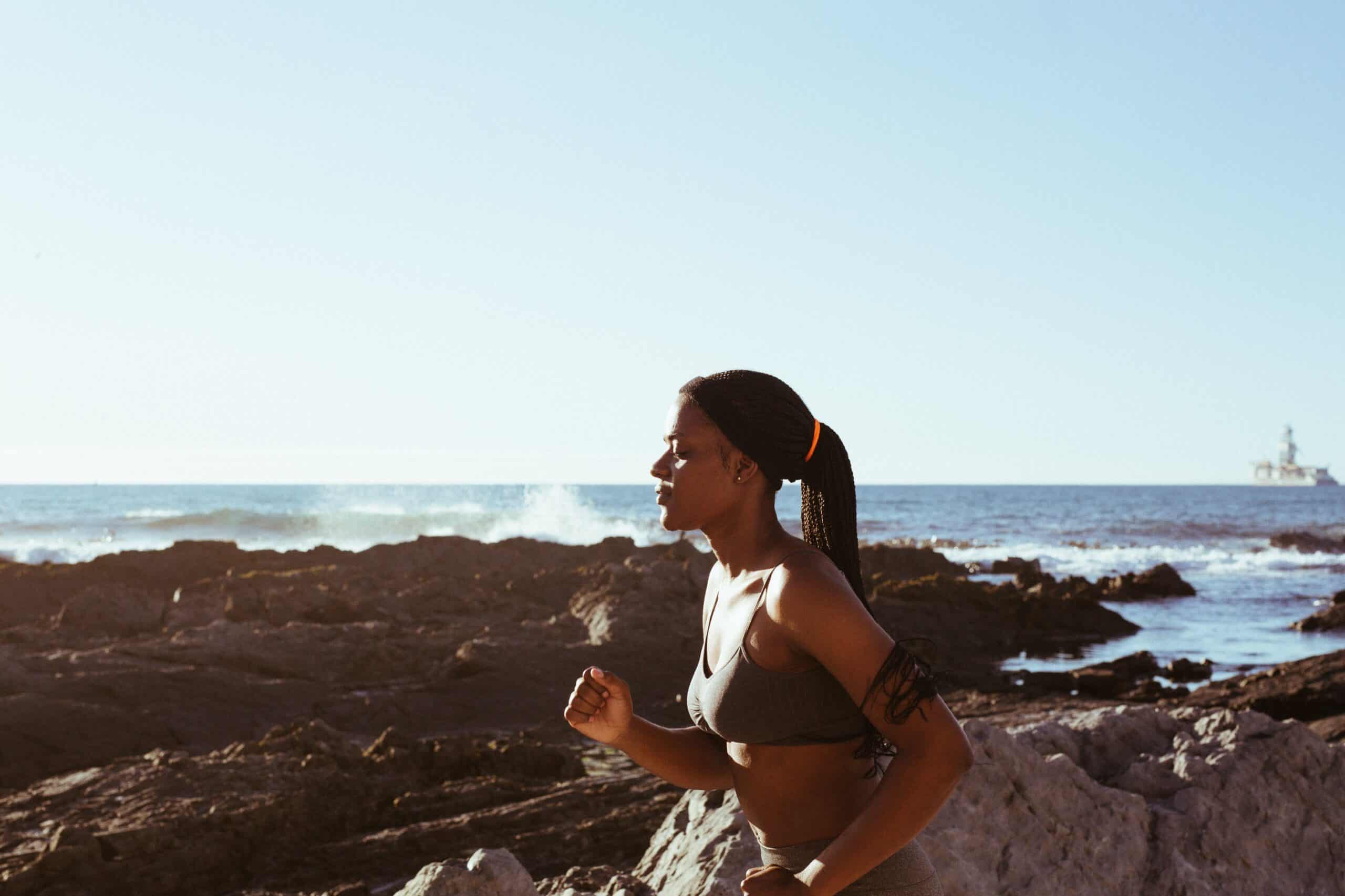 Runner along the coastline participating in Zone 2 running. 