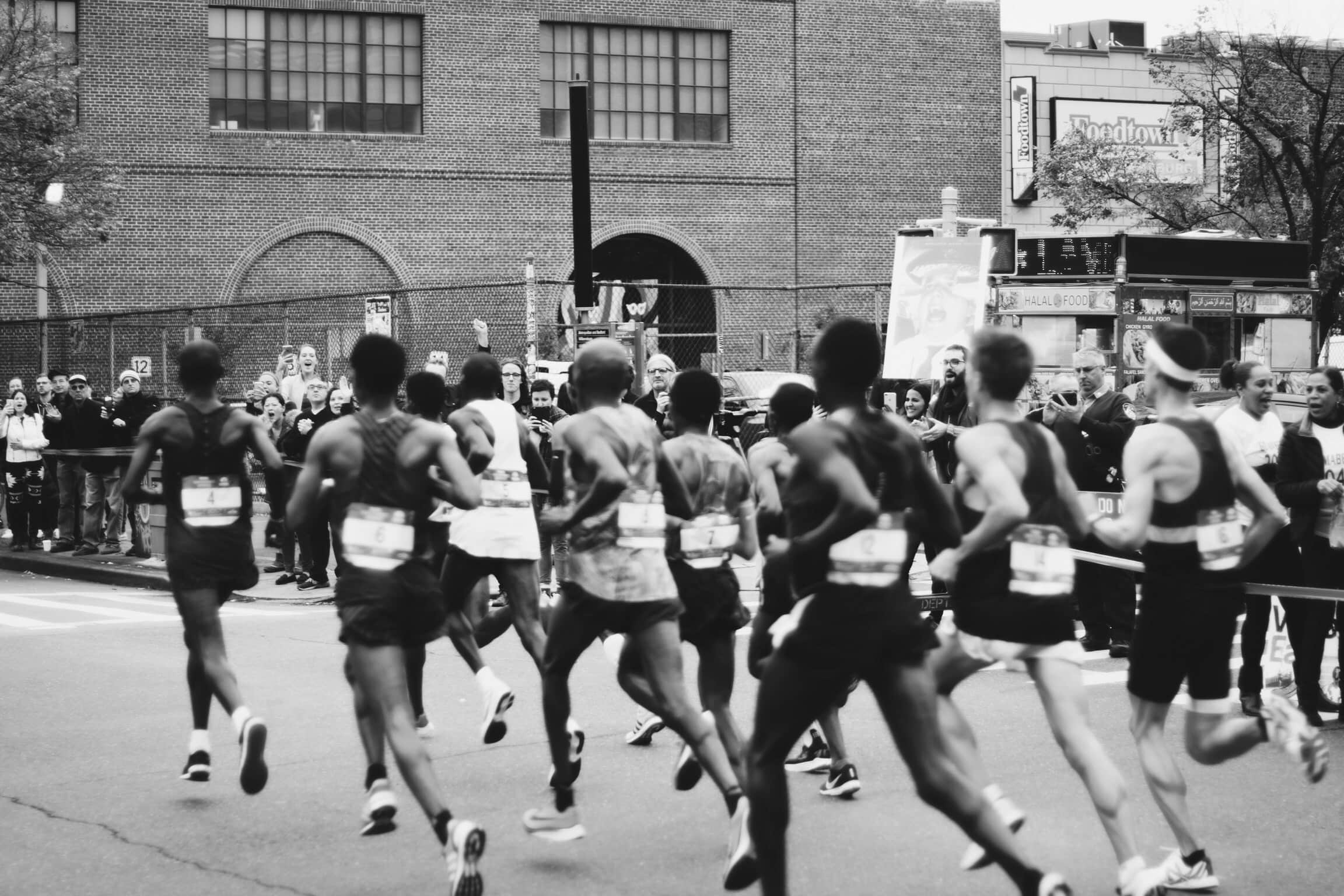 When is it ok to slow your half marathon pacing strategy. Runners along their half marathon.