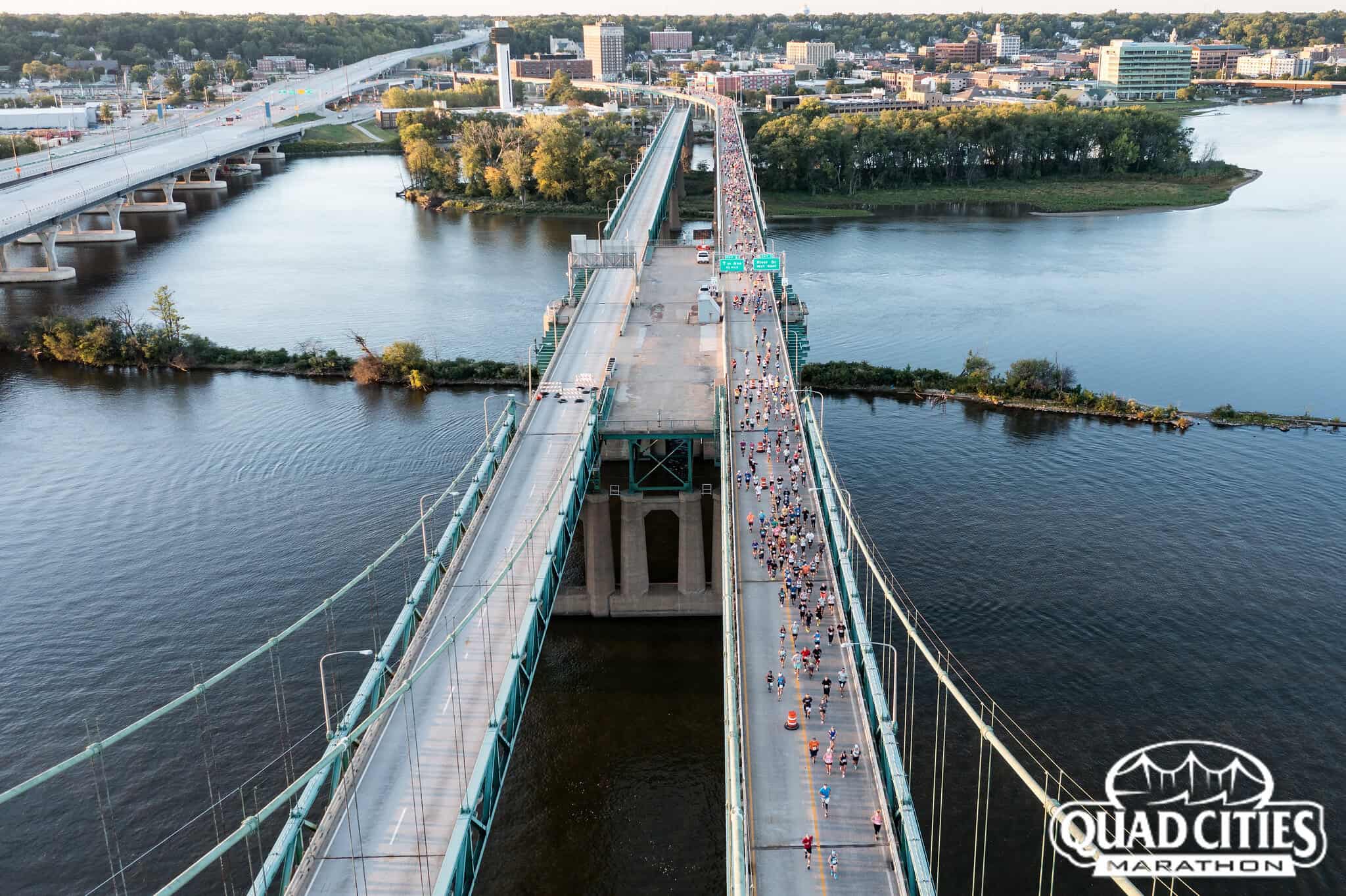 runners on a bridge in one of the best half marathons in the midwest, Quad Cities.